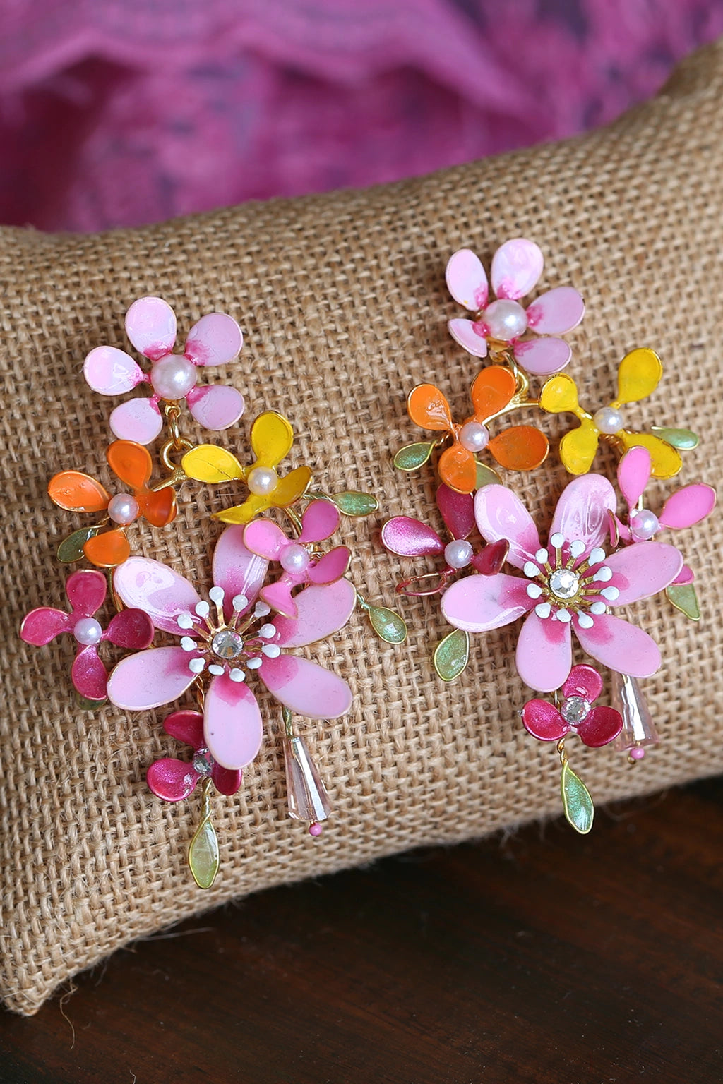 Handmade resin floral earrings with pink, orange, and yellow petals, pearl accents, and gold wire detailing – lightweight bridal earrings for haldi or mehndi.