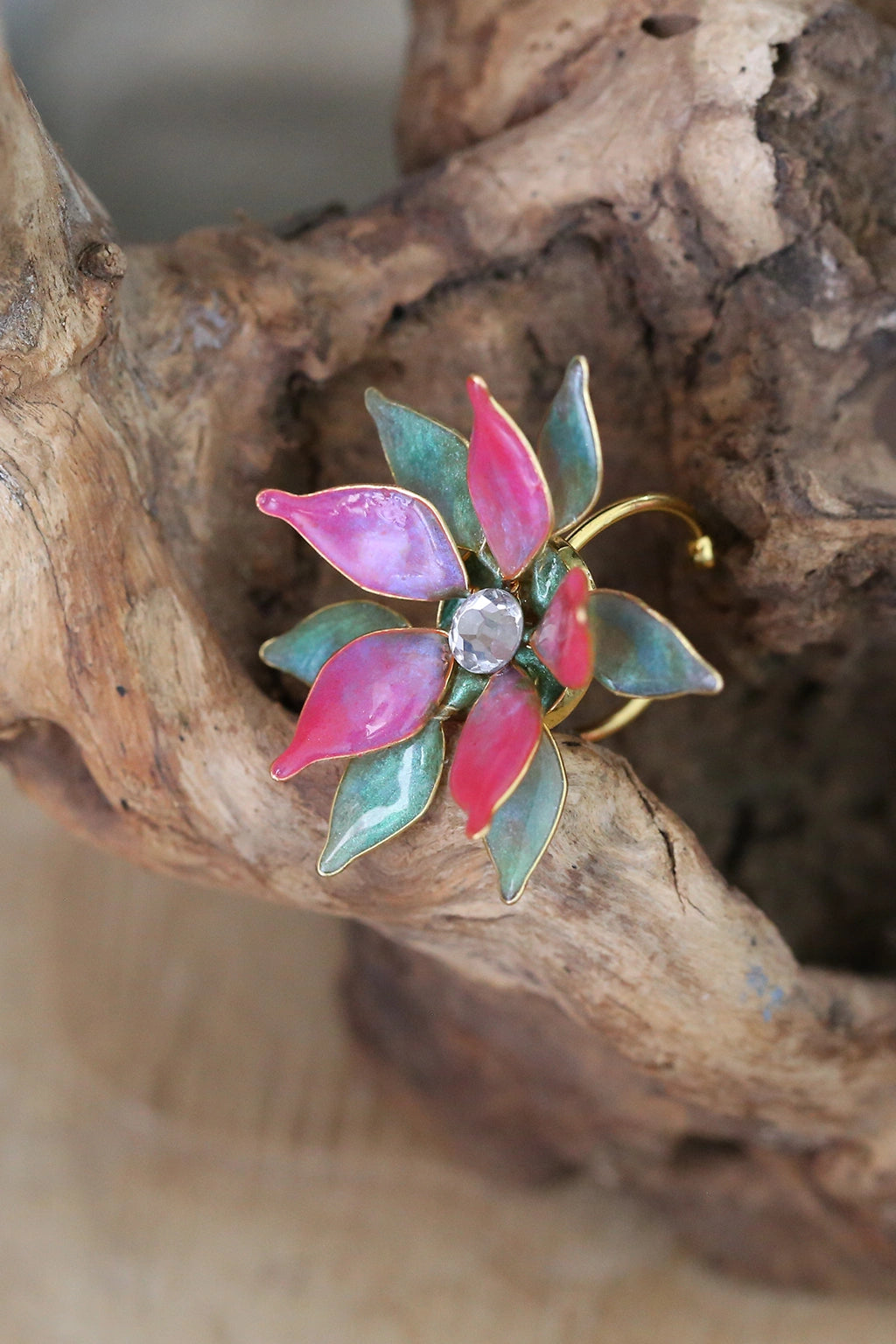 Handmade resin flower finger ring featuring pink flowers with green and gold leaves — learn to create this finger ring in the Rose Reverie resin jewelry class.