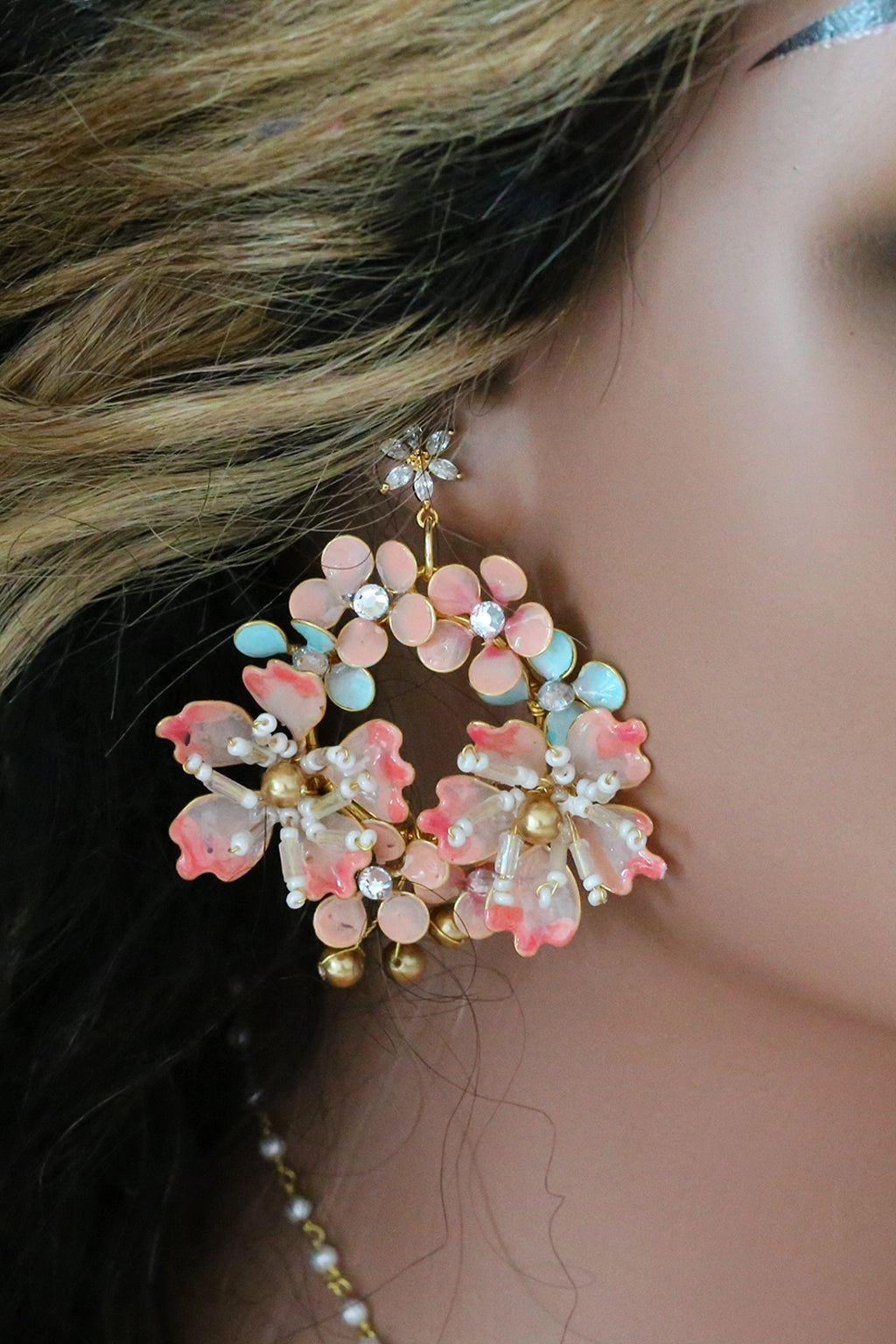 Close-up of Seraphina’s Bloom handmade resin floral bridal earrings in blush pink, aqua, and gold-plated copper – lightweight, customizable wedding jewelry by Seema Clay Jewelry.