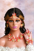 Handmade resin floral Haldi jewelry set for bride in red and lime green, including necklace, earrings, maang tikka and hathphool