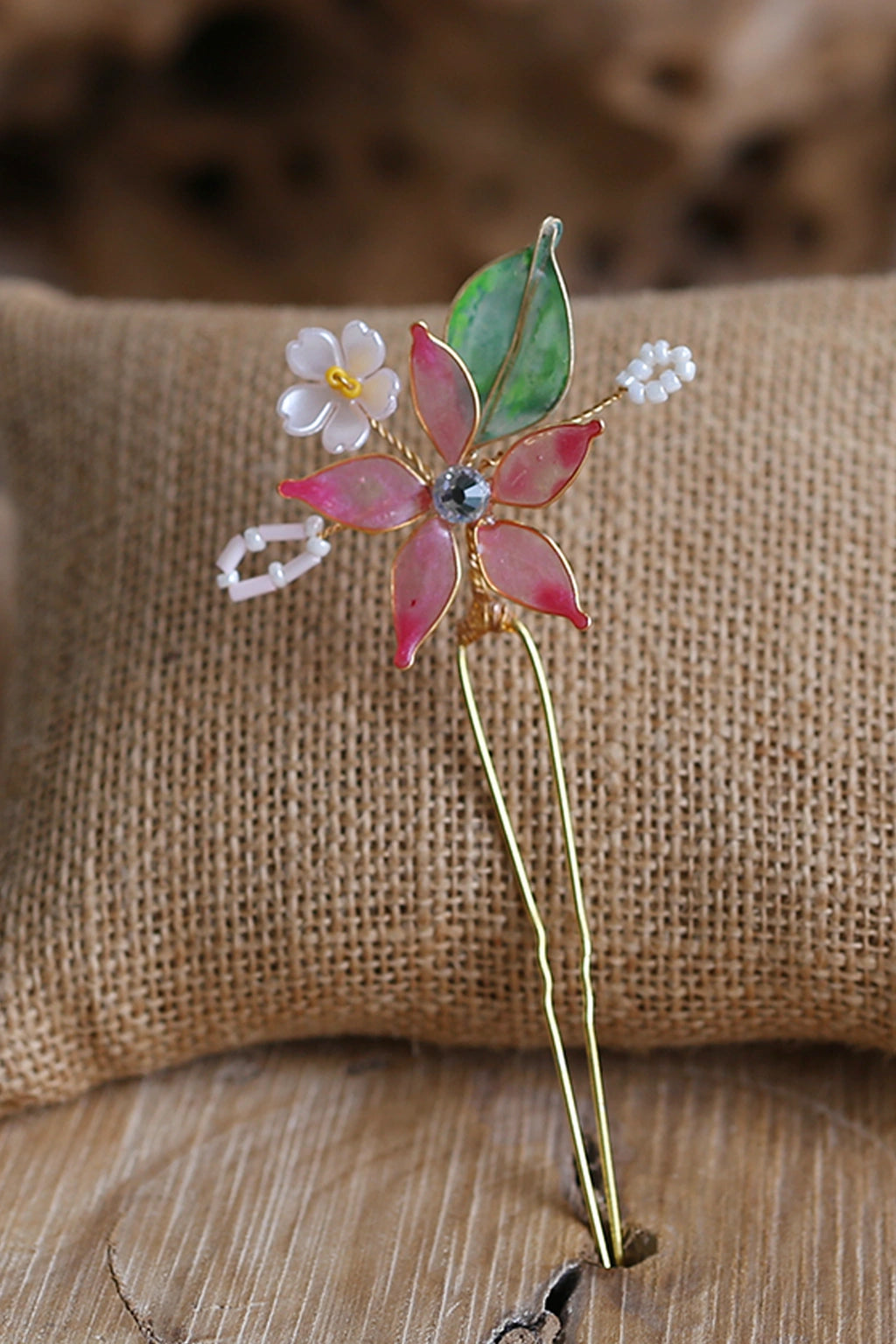 Handmade blush pink resin floral bridal hair pin with gold wire and leaf detailing