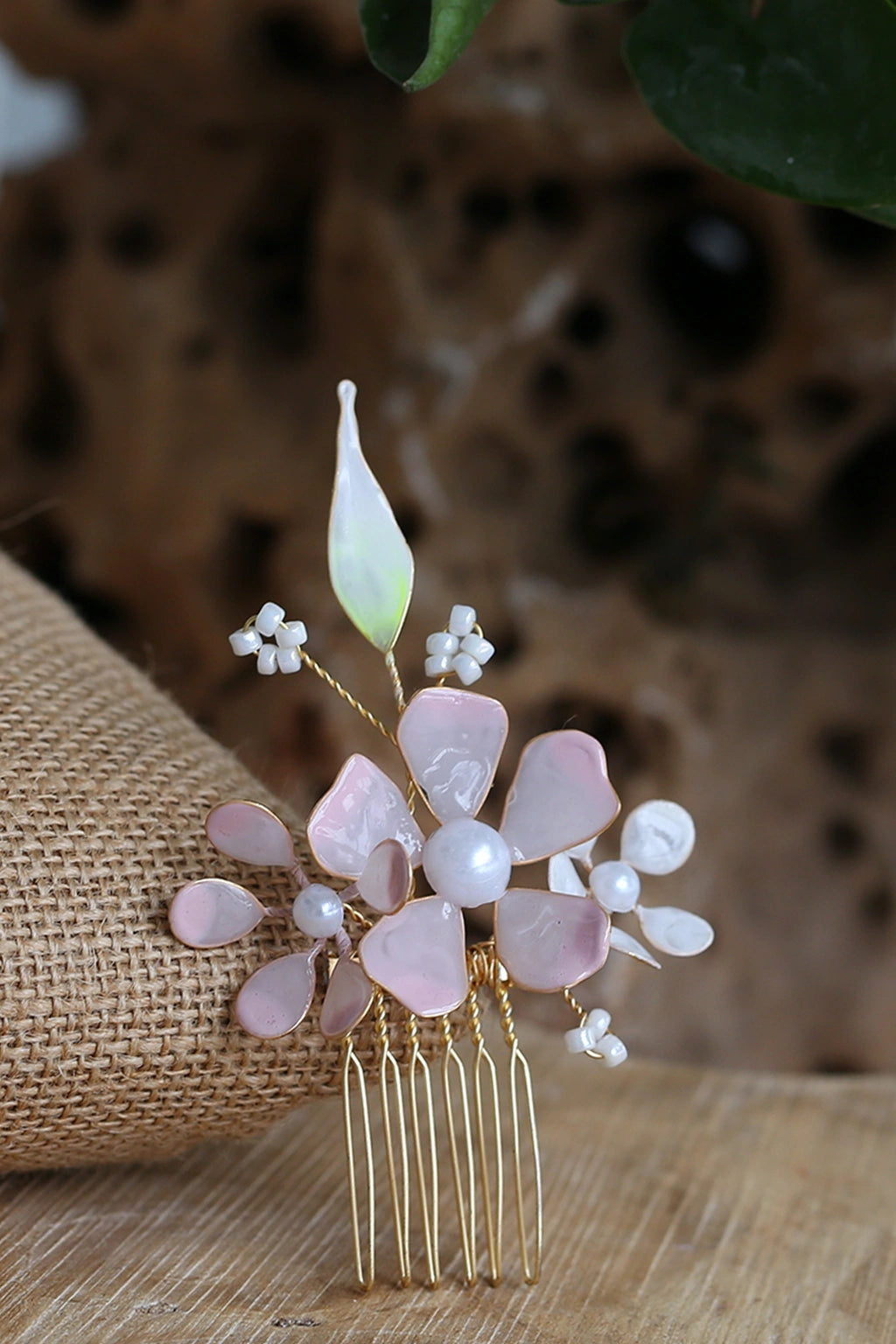Aurora’s Whisper handmade resin floral hair comb in blush pink and pearl with gold-plated copper wire – lightweight, customizable bridal hair accessory.