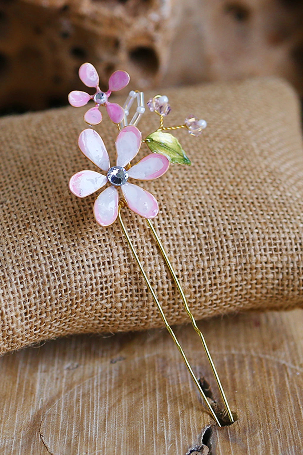 Handmade white and  pastel pink resin floral bridal hair pin with crystal centre and gold wire detailing, lightweight waterproof wedding hair accessory.