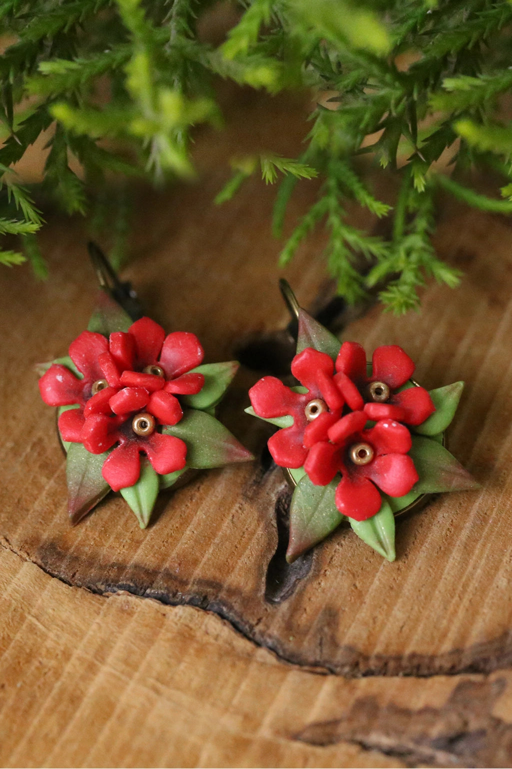 Handmade red flower earrings with green leaves crafted from lightweight waterproof polymer clay – customizable floral bridal jewelry