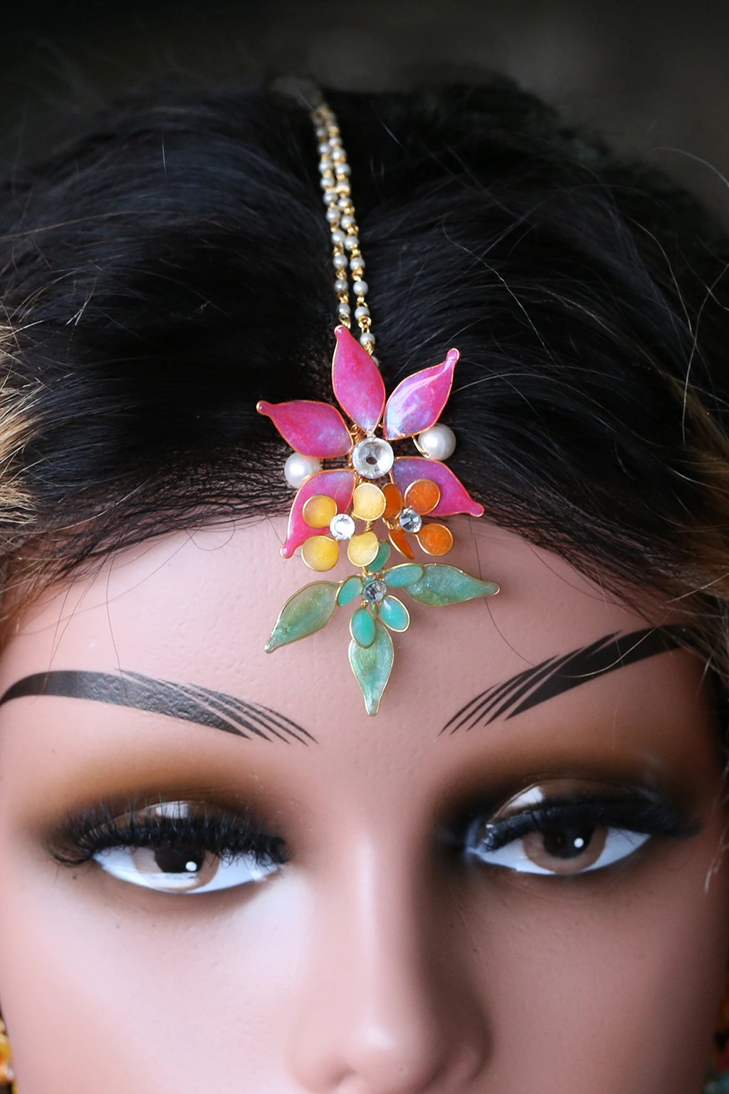 Mannequin wearing handmade resin flower maangtika set featuring pink flowers with green and gold leaves — learn to create this maangtika in  the Rose Reverie resin jewelry class.