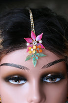 Mannequin wearing handmade resin flower maangtika set featuring pink flowers with green and gold leaves — learn to create this maangtika in  the Rose Reverie resin jewelry class.