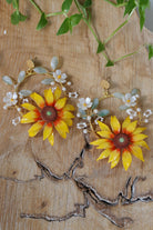Handcrafted resin sunflower earrings with delicate white and green floral accents, perfect for haldi, mehndi, bridal, and festive occasions. Lightweight and customizable.