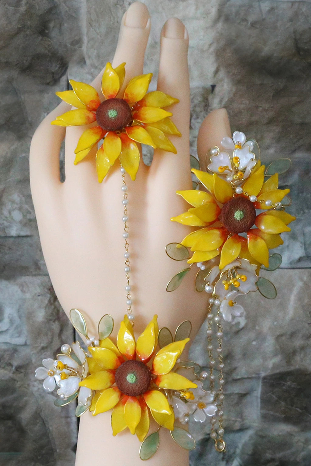 Handmade resin sunflower haathphool with gold-plated copper wire, pearl chain, and white floral accents – lightweight bridal hand jewelry for Haldi & Mehndi.