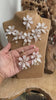 Video of White Pearl Resin Flower Bridal Jewelry Set showing necklace and earrings held in hand