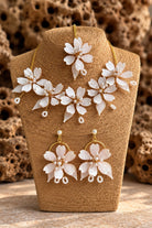 White Pearl Resin Flower Bridal Jewelry Set with Necklace, Earrings and Maangtika on display stand